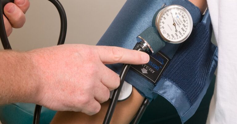 Clinician performing a cuff-based pulse volume recording assessment in an independent medical practice