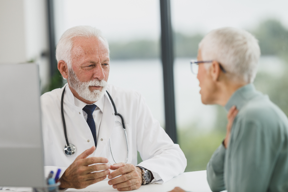 Physician discussing small fiber neuropathy testing options with an older patient in an exam room